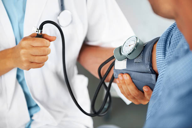 A doctor is checking the blood pressure of the patient